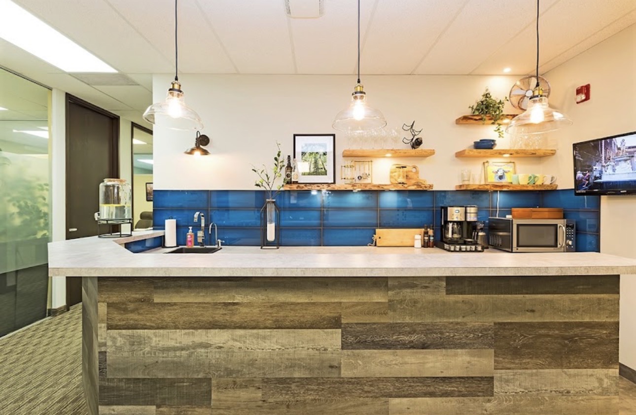 Reception and kitchen area with coffee, tea and water for clients